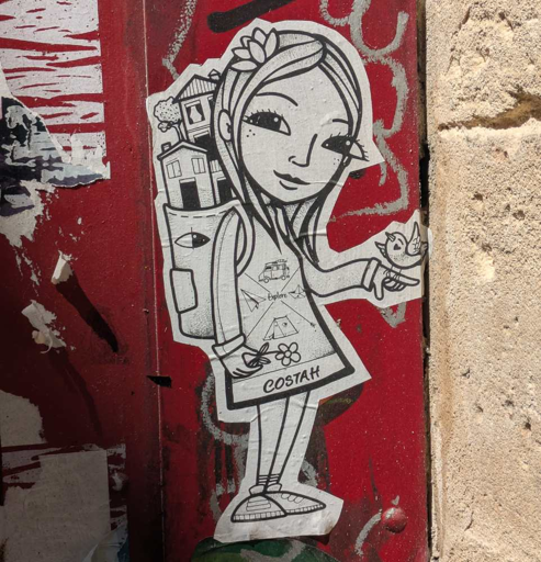 wheatpaste of a girl withhousee in her back pack and a bird sitting on her raised finger. white paper, black lines on red gate