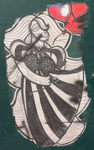 black and white person with long wavy hair and dress holding red heart shaped ballons. wheat pasted on green falt surface