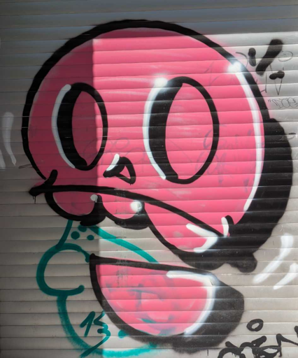 stylized pink skull with black outlines done as graffiti